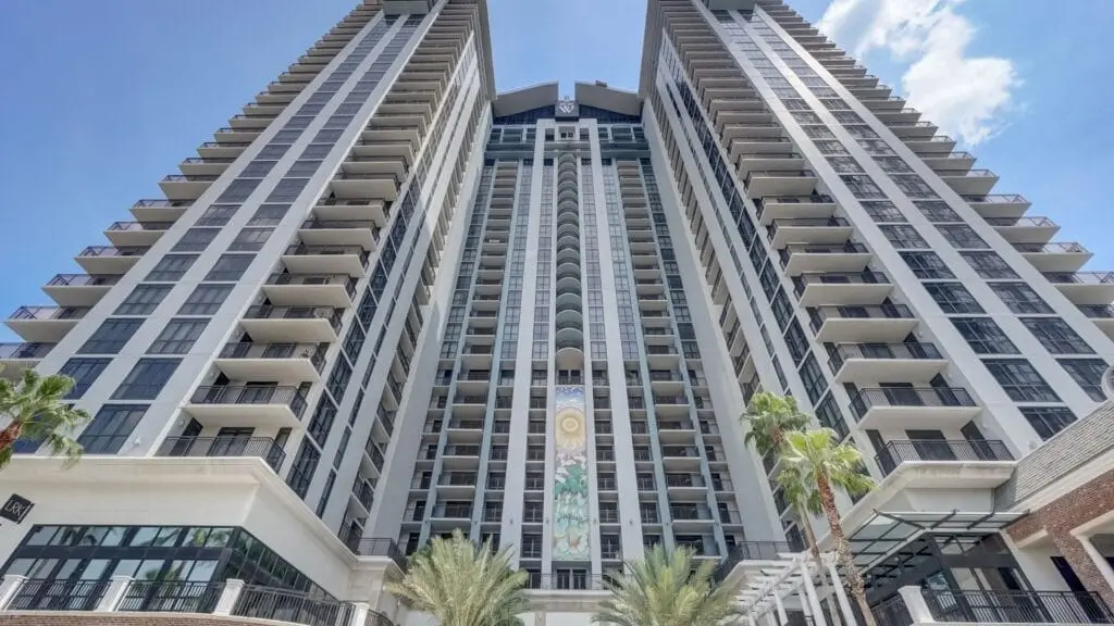Modern building exterior with glass facade at 55 West, showcasing architectural design and urban environment.